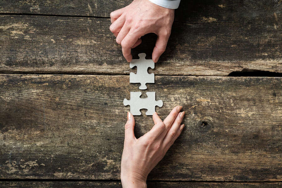 Pezzi di puzzle incastrati, simbolo di lavoro di squadra